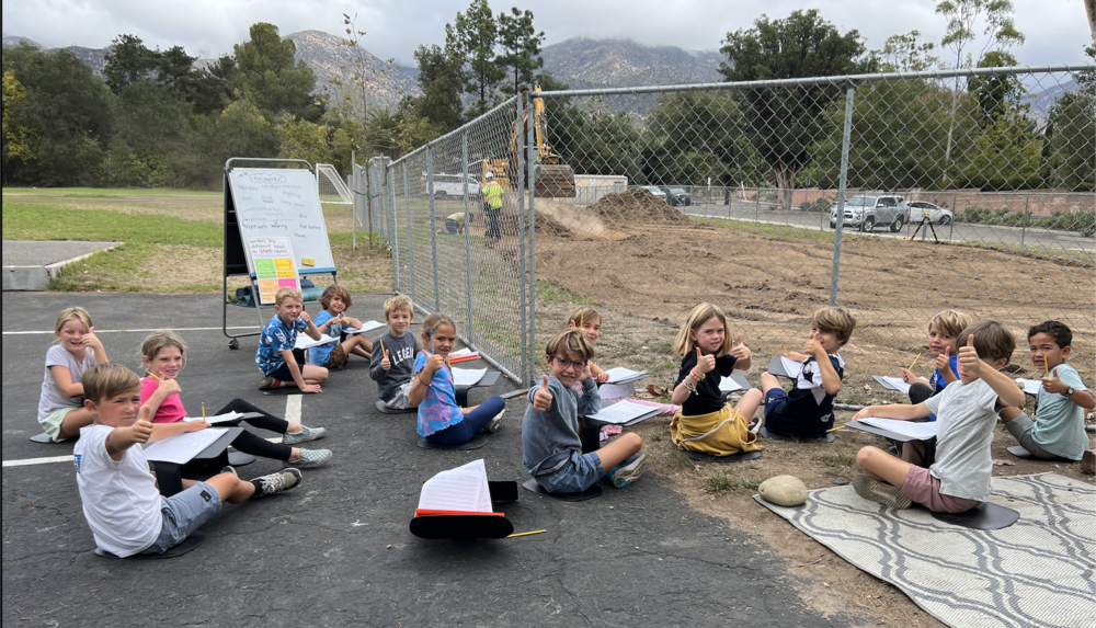 Students learning next to construction site